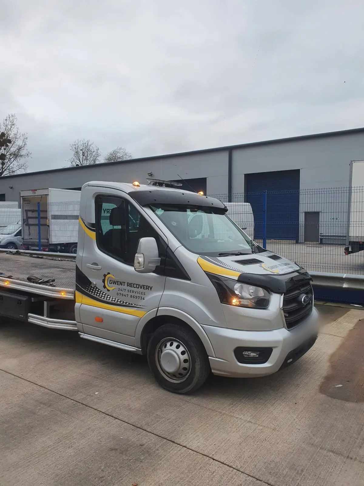 Gwent Recovery Ford Transit flatbed with yellow and black cut vinyl livery